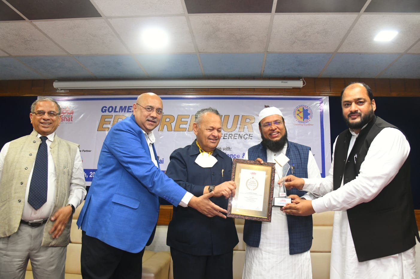 Mahbubul Hoque, Chancellor of USTM receiving Maeeshat Edu Doctor Award-2022 from the hands of P. A. Inamdar, Founder President, Azam Campus, Pune (centre) at Golmez Edupreneur Conference